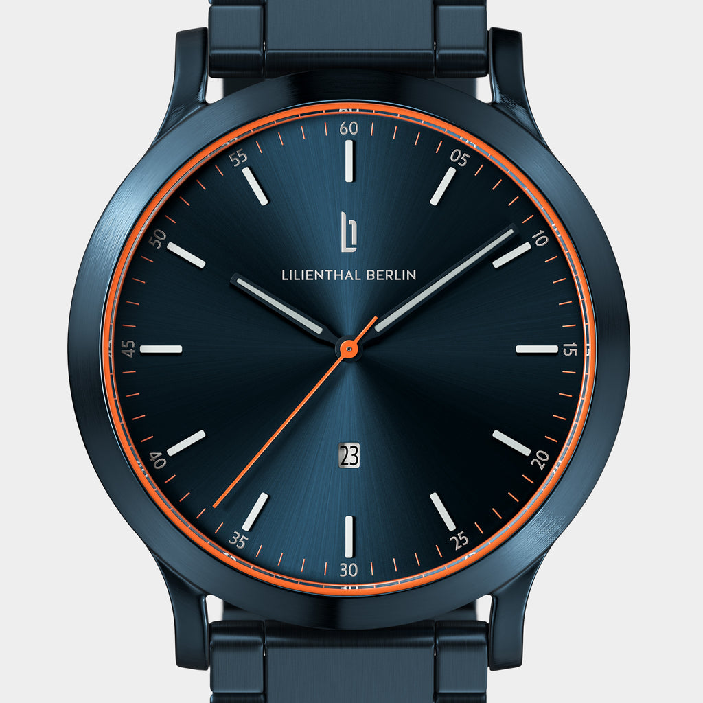 Sleek blue wristwatch with minimalist dial, orange accents, and date display.