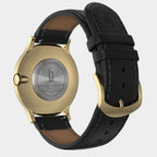 Gold stainless steel watch case with black leather strap, engraved back, and gold buckle