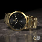 Gold wristwatch with black dial and date display on marble surface, German Design Award 2021