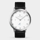 Minimalist wristwatch with silver case, white dial, black leather strap, and sleek markers