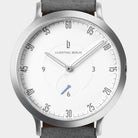 Minimalist silver wristwatch with white dial, black numerals, and grey leather strap