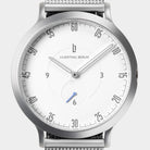 Minimalist silver wristwatch with white dial, mesh strap, and modern hour markers.
