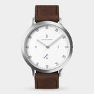 Minimalist silver watch with white dial, brown leather strap, and slim markers
