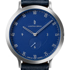 Minimalist blue watch face with silver hour markers, subdial, and leather strap