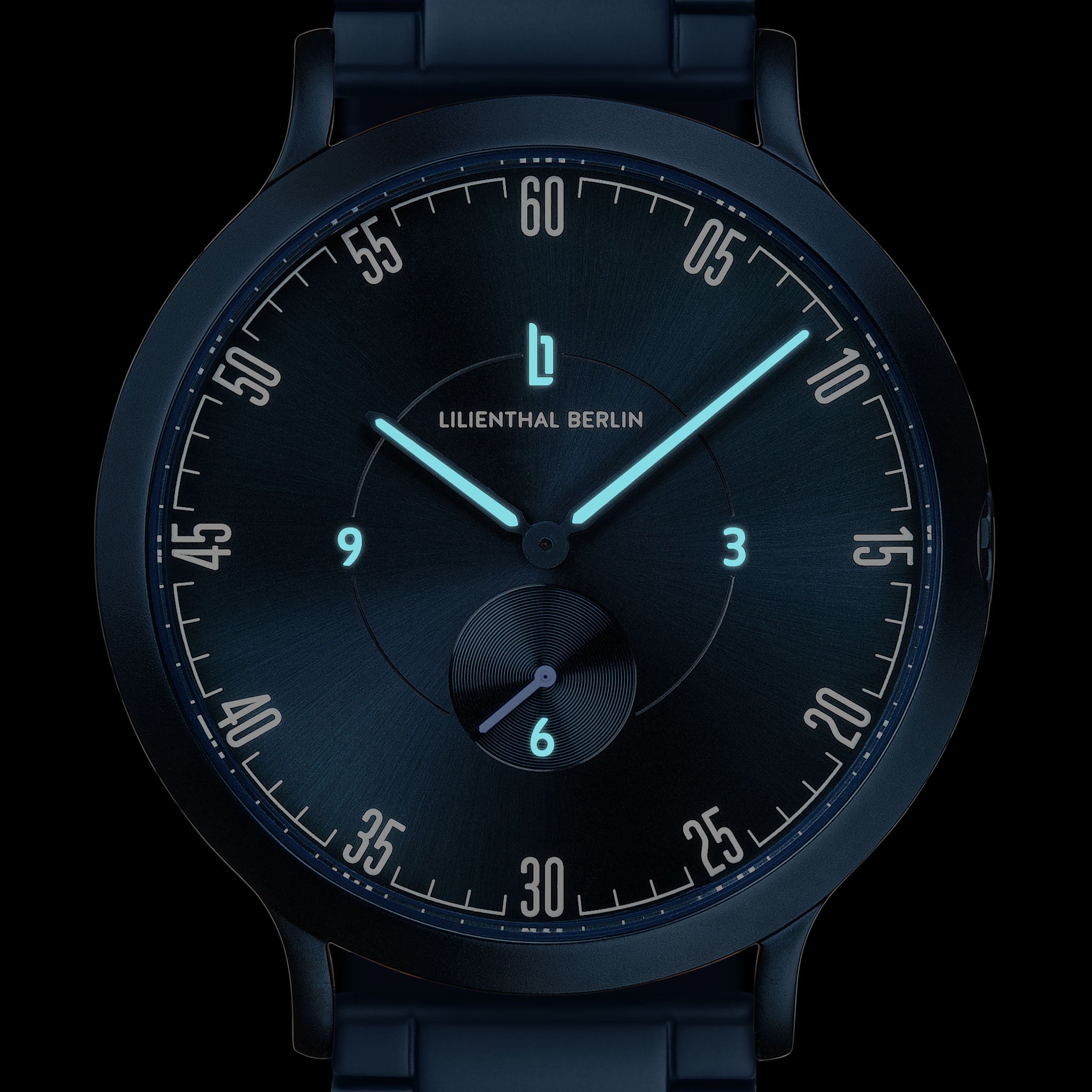 Modern black watch with blue luminous hands and minimalist dial, close-up on face