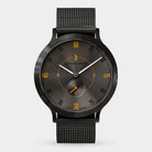 Black mesh strap watch with dark dial and orange accents, minimalist modern design