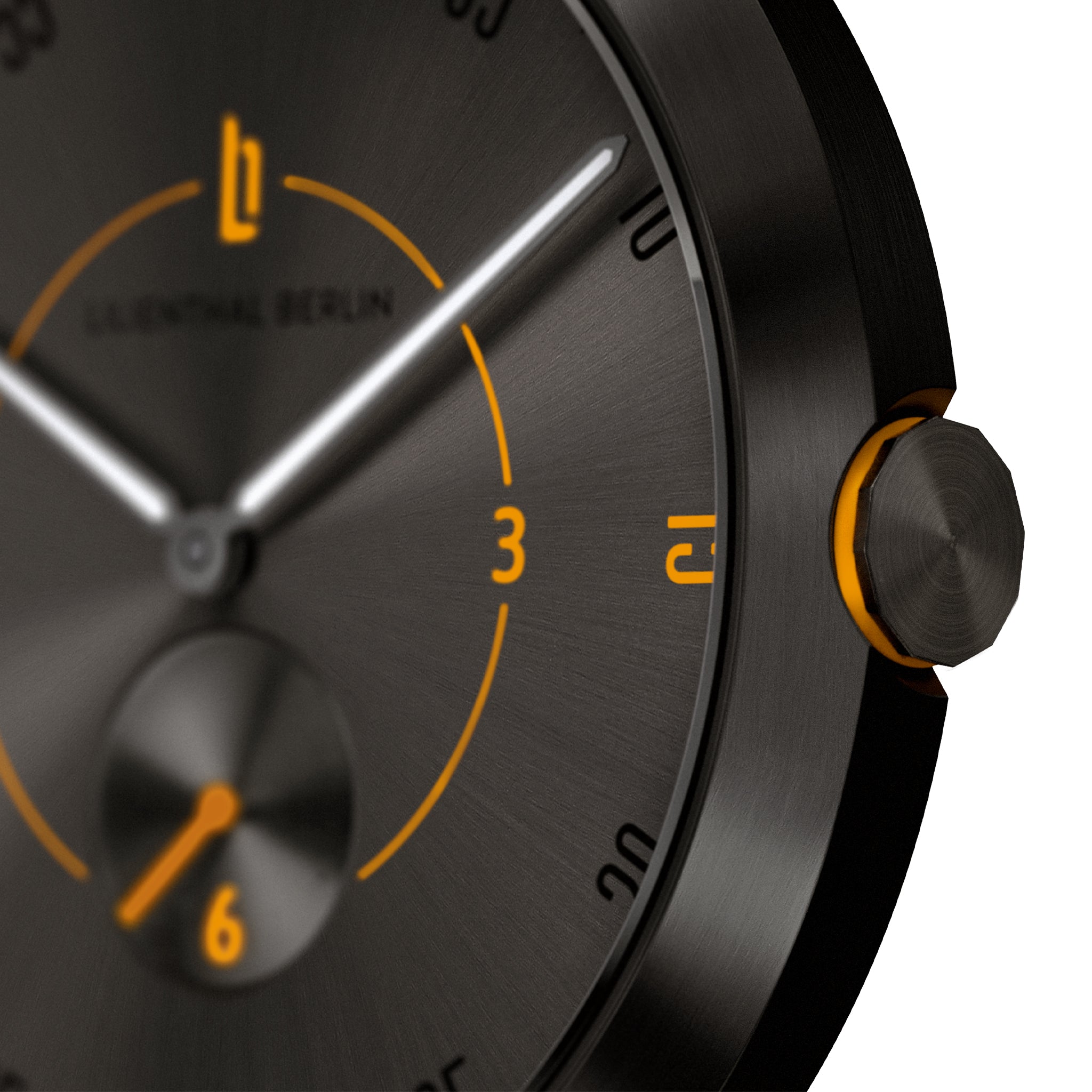 Close-up of black watch face with orange accents and brushed metal finish