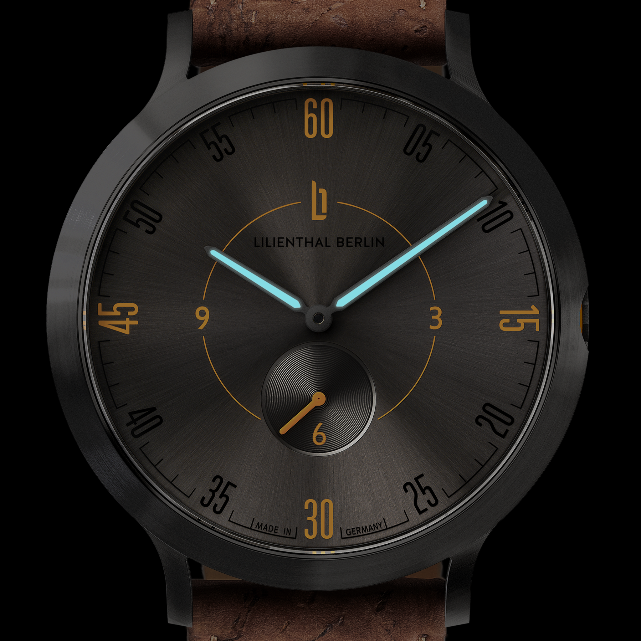 Black minimalist wristwatch with brown leather strap, sunburst dial, blue hands, and gold accents