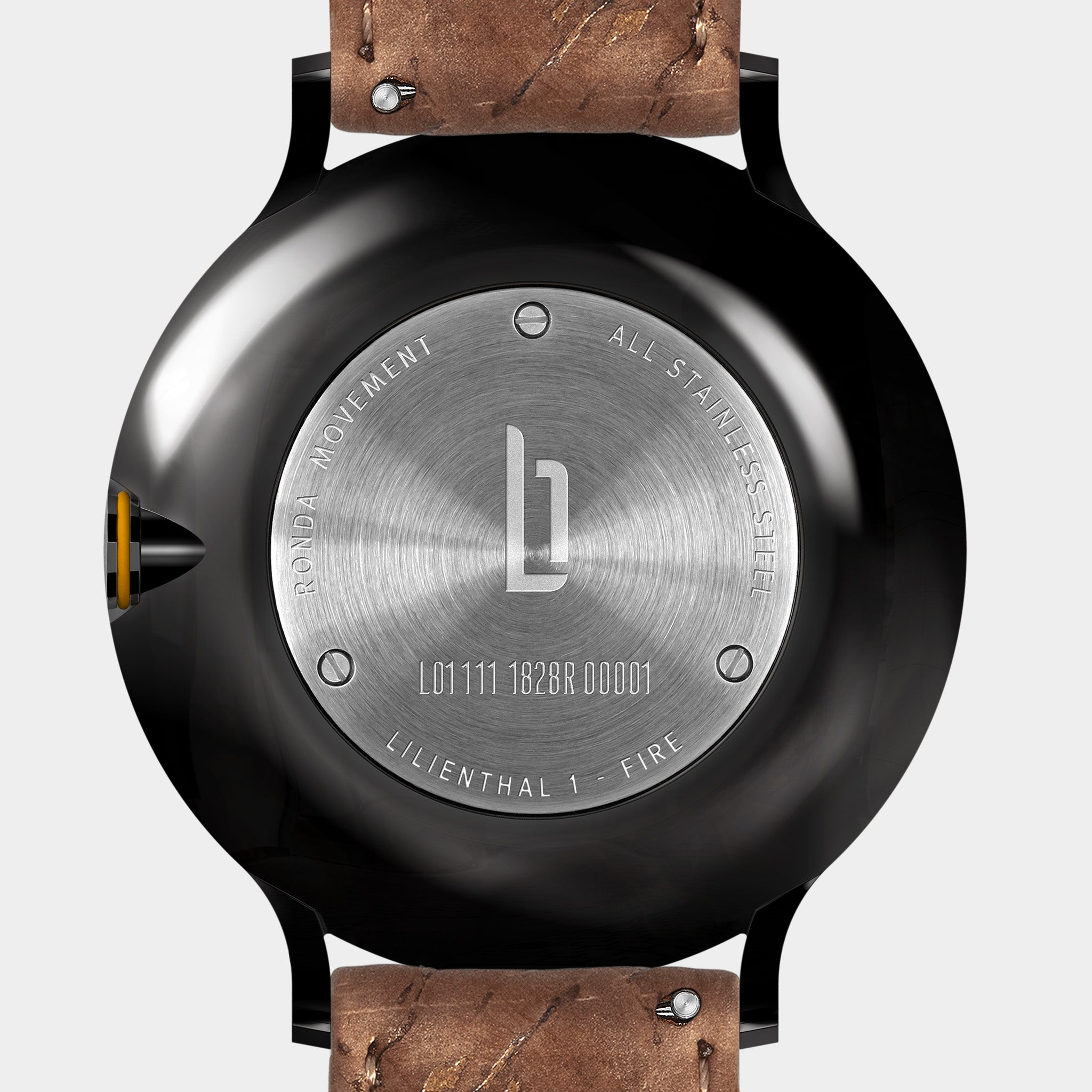 Stainless steel watch case back with engraved details and brown leather strap