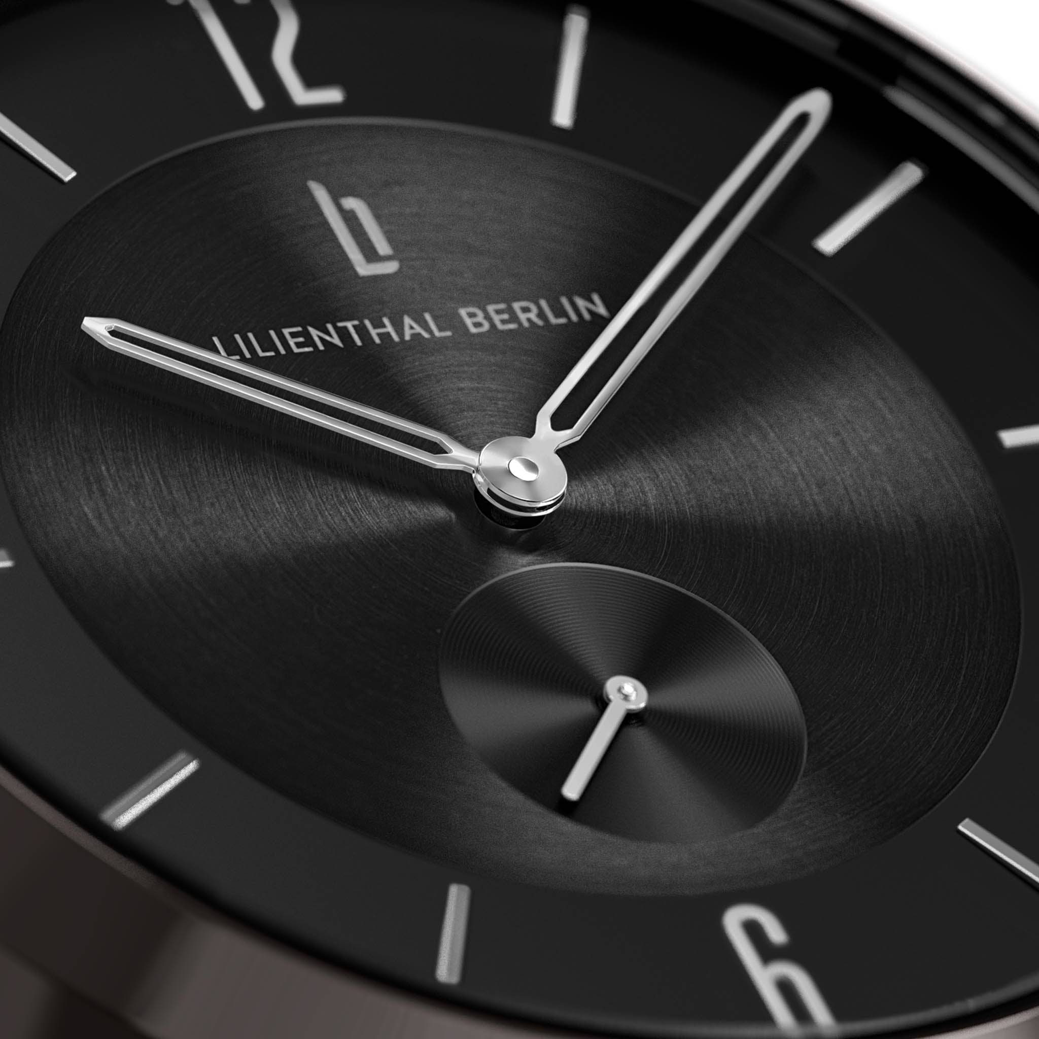Close-up of a minimalist black watch face with silver hands and hour markers