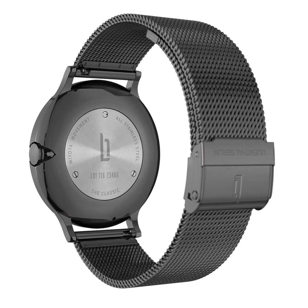 Stainless steel watch case back with mesh strap and engraved clasp, modern minimalist design
