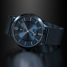 Modern black mesh strap watch with minimalist blue dial and rose gold hour markers
