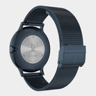 Stainless steel mesh watch with engraved case back and black clasp, modern minimalist design