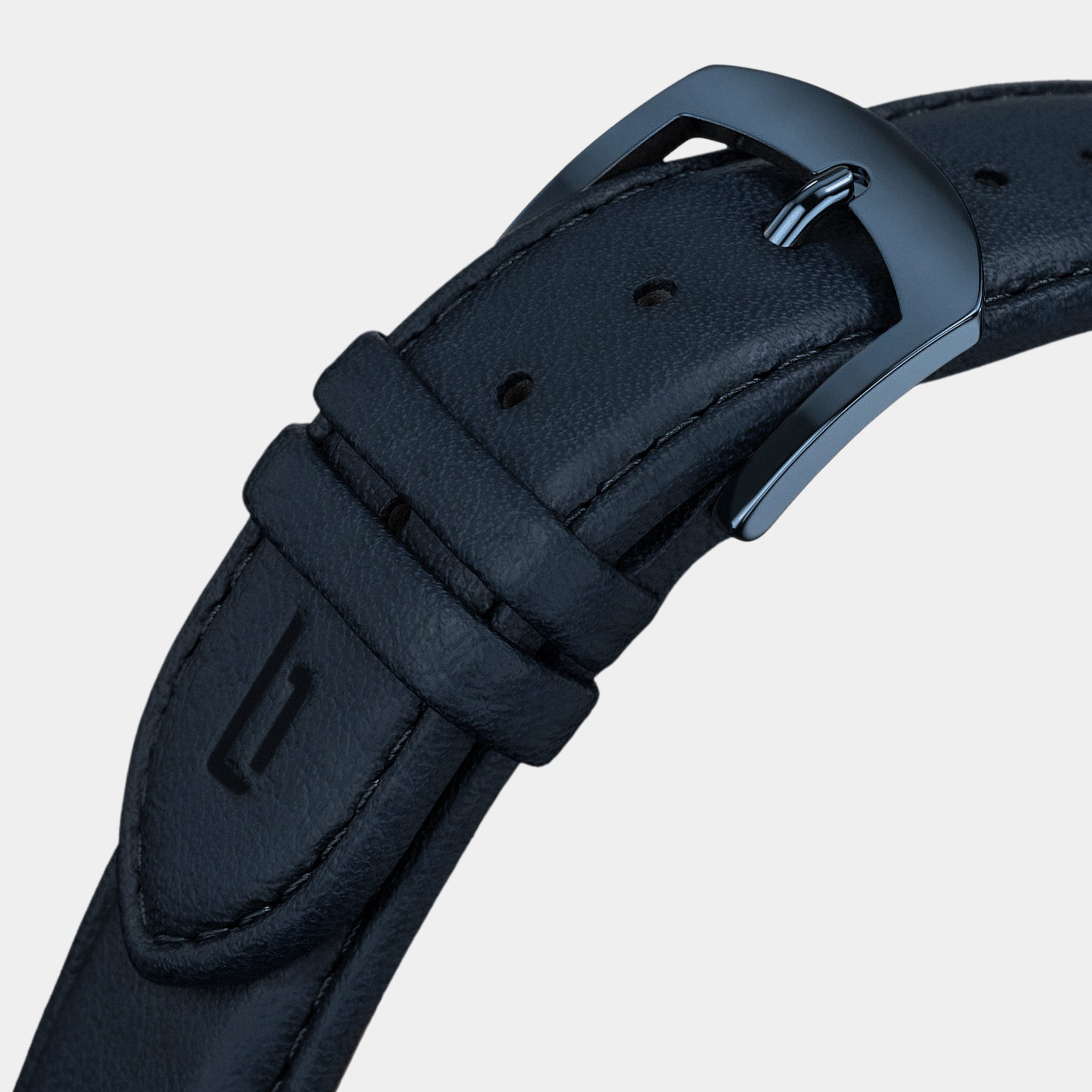 Close-up of navy leather watch strap with steel buckle and stitched detail